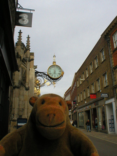 Mr Monkey looking at the clock outside St Martin le Grand