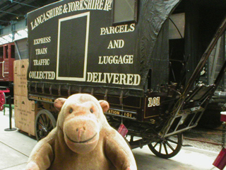 Mr Monkey looking at a horse drawn delivery van