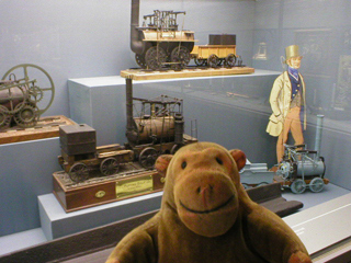 Mr Monkey looking at models of early locomotives