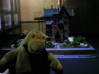 Mr Monkey looking at a model of Cuypers' design for a Heineken beer house on Vondelstraat