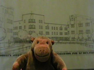 Mr Monkey looking at architects drawings of the Amsterdam-Zuid development