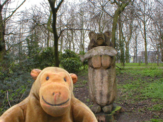 Mr Monkey with a wooden statue of a bear