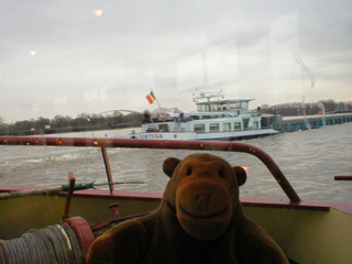 Mr Monkey looking at the stern of a Belgian barge
