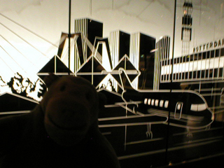 Mr Monkey looking at a decorative panel near the depature gate
