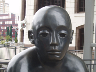 The face of one of Giles Penny's Two Men on a Bench