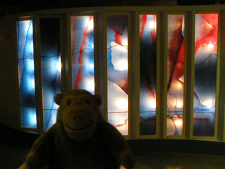 Mr Monkey looking at the War and Peace stained glass panels