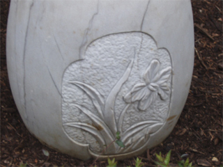 A plant carved on a stone seat