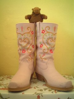 Mr Monkey wearing boots which are far too big for him
