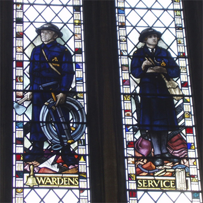 Wardens Service - a man with a stirrup pump and a woman taking notes Wardens Service - a man with a stirrup pump and a woman taking notes