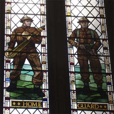 Home Guard - two men in battle dress, one with an artillery shell, one with a sten gun Home Guard - two men in battle dress, one with an artillery shell, one with a sten gun