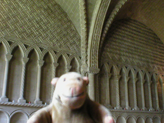 Mr Monkey looking at blind arcading and vaulting in the chapter house