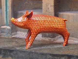 A pig covered in orange and golden scales