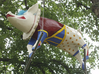 Grimaldi the pig on his trapezes