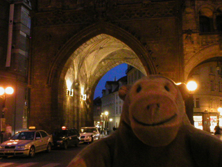 Mr Monkey looking at the gateway under the Powder Tower at night