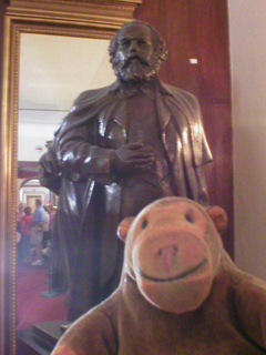 Mr Monkey looking at a statue of Karl Marx