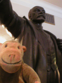 Mr Monkey looking at a statue of Lenin
