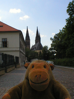 Mr Monkey looking up K Rotundé towards the church of Saints Peter and Paul