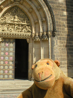 Mr Monkey looking at the main door of the church