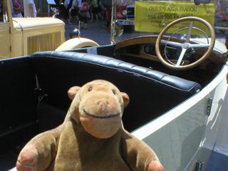 Mr Monkey getting into the vintage car