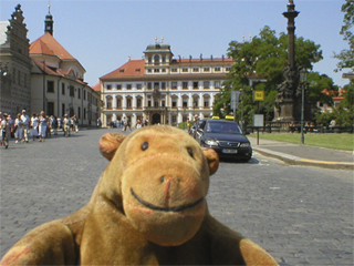 Mr Monkey looking at Toskánský palace on the west side of Hradčanské námeští