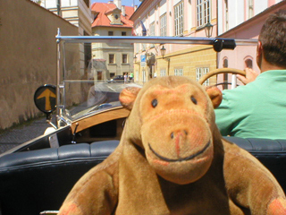 Mr Monkey driving away from Hradčanské námeští