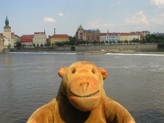 Mr Monkey looking across the Vltava from the Little Quarter riverside