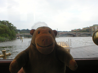 Mr Monkey looking up the river to the Mánesův Bridge