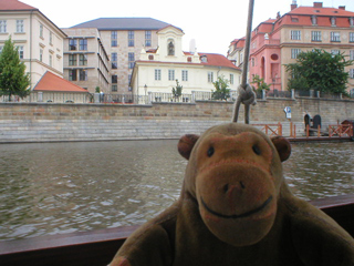 Mr Monkey looking at buildings along the Vltava