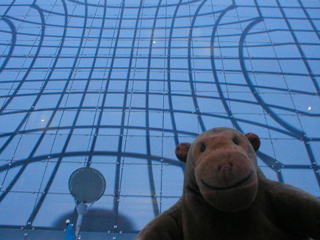 Mr Monkey looking up at the outside of Urbis