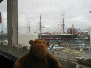 Mr Monkey looking at HMS Warrior from the railway station