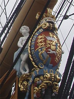 The coat of arms of George III posing as the figurehead of HMS Victory
