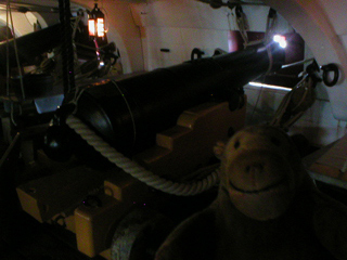 Mr Monkey looking at a 32 pounder gun