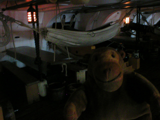Mr Monkey looking at hammocks and mess tables on the lower gundeck