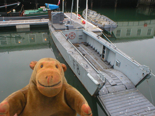 Mr Monkey looking at the Landing Craft, Infantry in the Mast Pond
