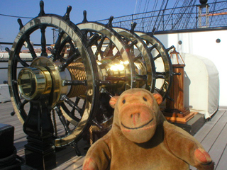 Mr Monkey looking at the four ship's wheels on the upper deck