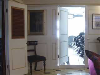 Anchor chain visible through a door in the captain's cabin