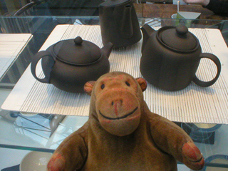 Mr Monkey looking at Lucy Whiting's rocking teapots