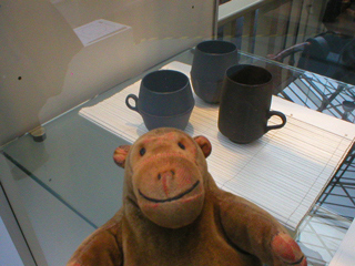 Mr Monkey looking at mugs by Lucy Whiting