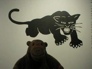 Mr Monkey looking at the Black Panther symbol