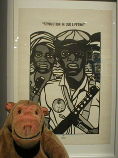 Mr Monkey looking at the REVOLUTION IN OUR LIFETIME poster