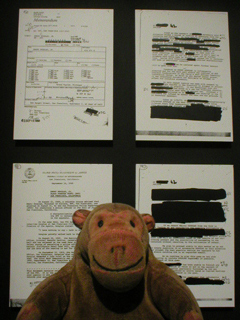 Mr Monkey looking at pages from the FBI file on Emory Douglas
