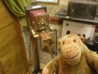 Mr Monkey looking at a Victorian camera