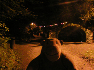 Mr Monkey looking at a stone shelter along the Lover's Walk