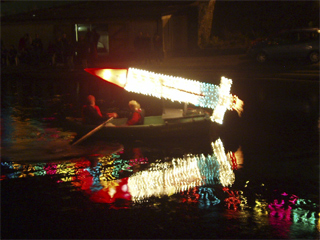 Thunderbird One being carried by a rowing boat