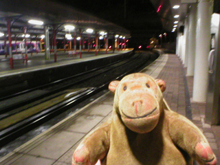 Mr Monkey waiting on a deserted station platform