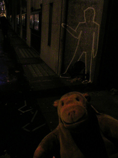 Mr Monkey examining outlines outside Saint Martins College of Art and Design