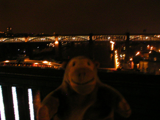 Mr Monkey looking down from the Tyne Bridge at night