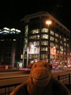 Mr Monkey looking at the coloured glass panels on the side of D K B House