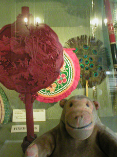 Mr Monkey looking at the Chinese ceremonial fan