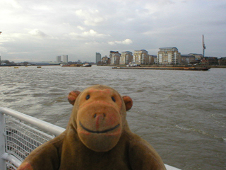 Mr Monkey looking at barges on the river at Greenwich
